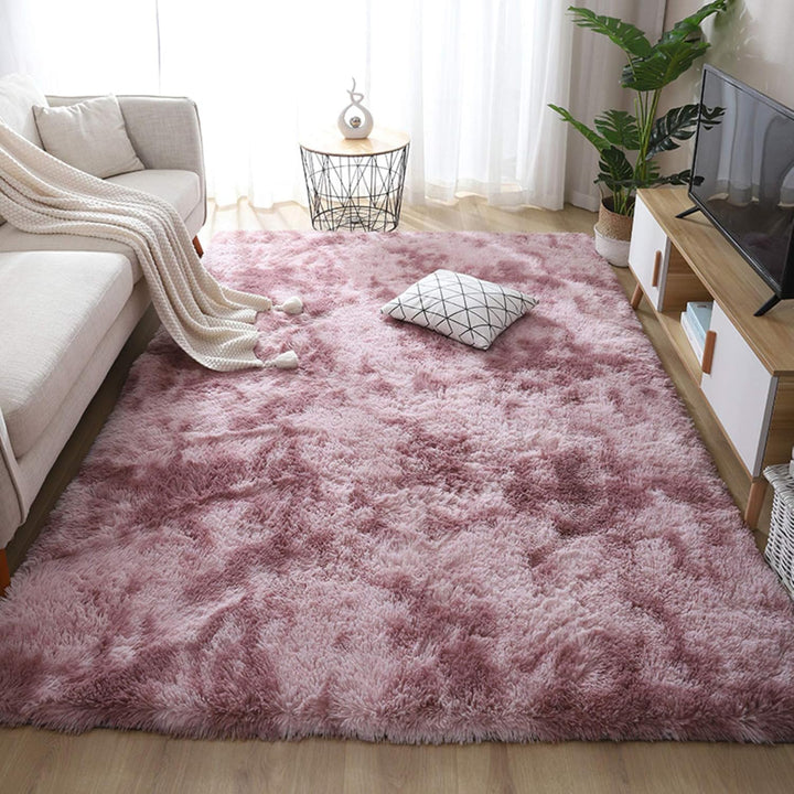 VibeCore Tie-Dye Area Rug Mauve on living room floor, soft polyester fiber rug with vibrant mauve tie-dye pattern, non-slip backing for safety, perfect for modern living room decor.