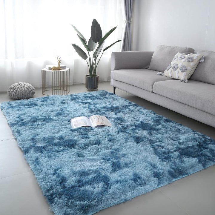 VibeCore Tie-Dye Area Rug Sky Blue on living room floor, soft polyester fiber rug with vibrant sky blue tie-dye pattern, non-slip backing for safety, perfect for modern living room decor.