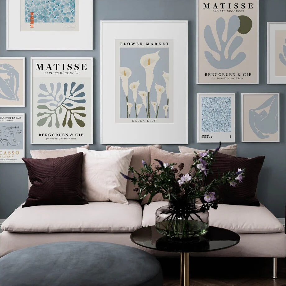 VibeCore Timeless Blue Canvas Posters wall collage displayed in a living room. Featuring pastel blue abstract prints inspired by Matisse, Picasso, and flower markets, these contemporary art pieces add a serene and artistic touch to the space.
