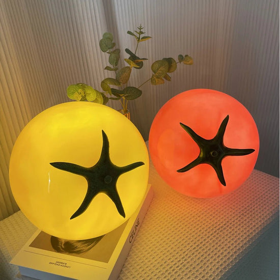 A vibrant and playful lamp featuring a combination of yellow and red glass, glowing warmly to bring a unique touch of charm to any room.