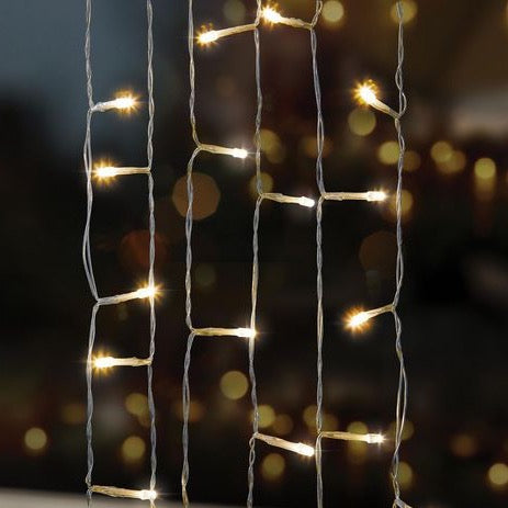 Close-up of VibeCore traditional string lights in warm white, glowing softly to create a cozy and inviting ambiance.