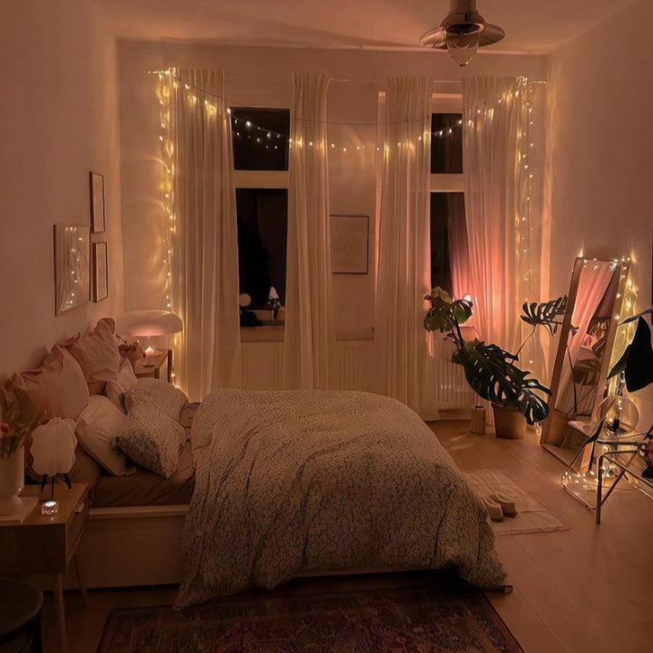 VibeCore traditional string lights in warm white, illuminating the bedroom with a soft, cozy glow, creating a relaxing atmosphere.