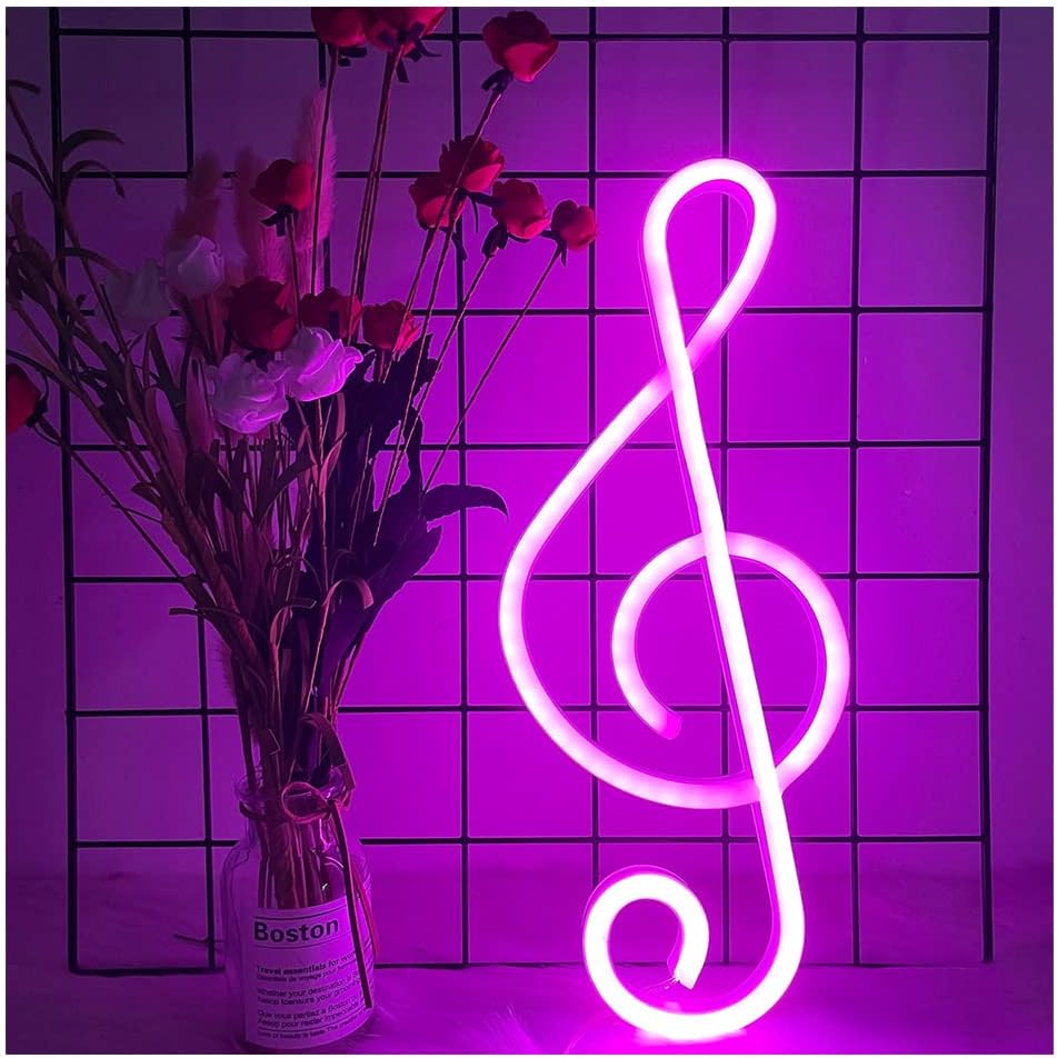 Treble Clef Neon Light in pink glowing softly against a wall, creating a vibrant and musical ambiance in the room.
