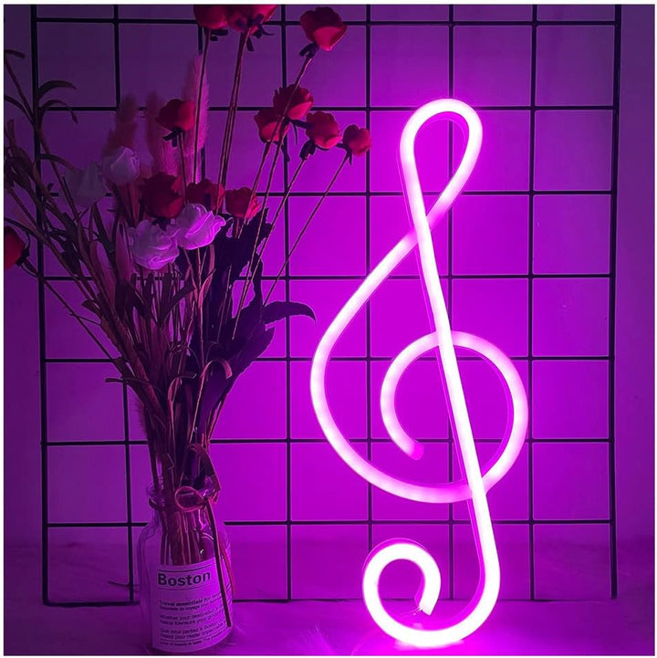 Treble Clef Neon Light in pink glowing softly against a wall, creating a vibrant and musical ambiance in the room.