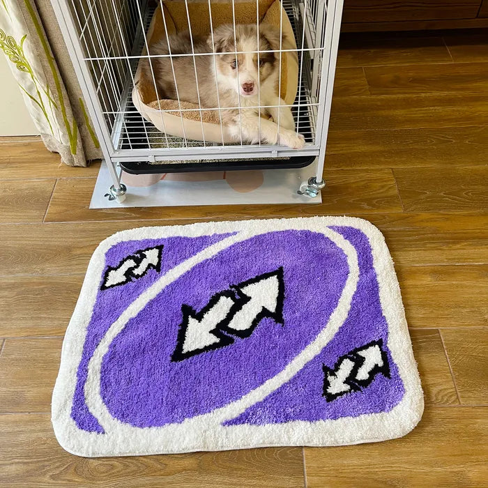 VibeCore UNO Reverse Accent Rug in front of a dog crate, showcasing its playful purple design and nostalgic UNO theme. This fun rug adds a pop of color and personality, making it a unique addition to any space while maintaining comfort and style.