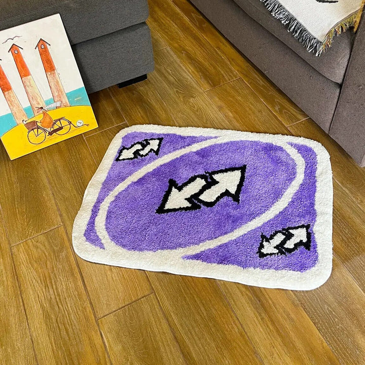 VibeCore UNO Reverse Accent Rug in the living room, adding a playful twist with its purple color and nostalgic UNO design. The rug enhances the modern, vibrant aesthetic of the space while providing a soft and comfortable feel, perfect for urban and contemporary decor.