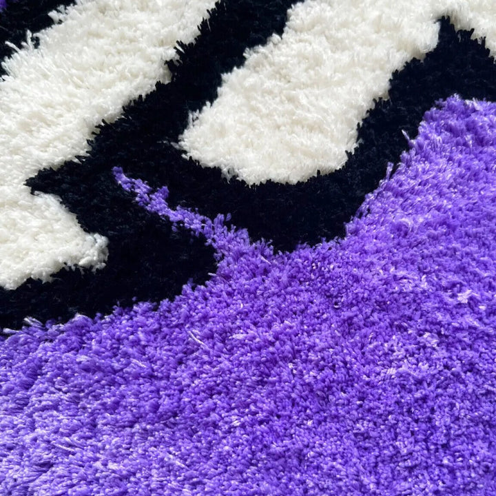 VibeCore UNO Reverse Accent Rug close-up of material, showcasing its soft, plush texture and high-quality fabric. The vibrant purple color and intricate design provide a cozy, stylish feel while ensuring durability and comfort.