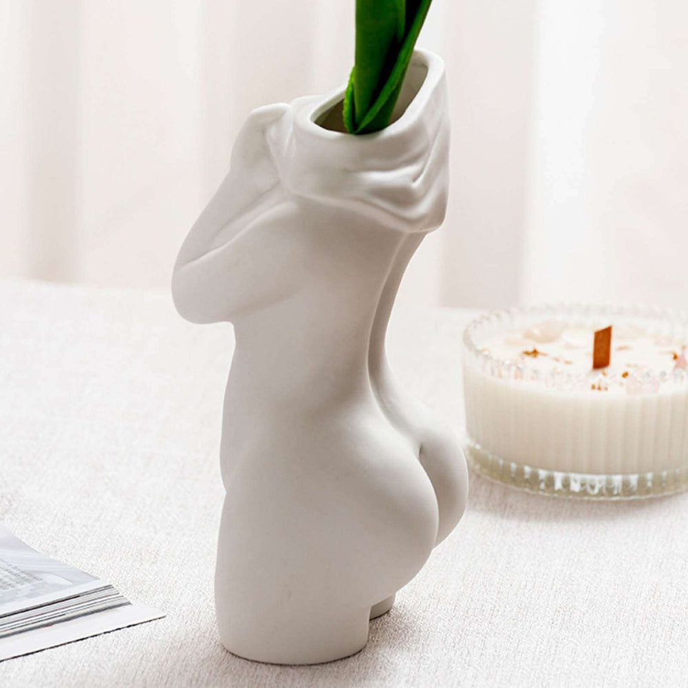 VibeCore Undressing Woman Vase, minimalist white porcelain sculpture with smooth curves, showcasing artistic craftsmanship. Elegant female form as unique home decor piece for modern spaces.