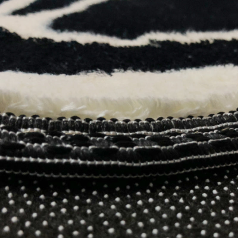 Close-up view of the VibeCore Vans Vault Skateboard Accent Rug's material, showcasing its plush, soft texture. The high-quality fabric provides a cozy feel underfoot, while the bold skateboard design adds a unique touch to any space. The rug's non-slip backing ensures stability, making it perfect for high-traffic areas like bedrooms, dorm rooms, or living rooms. This durable, easy-to-clean rug offers both style and comfort for your contemporary decor.