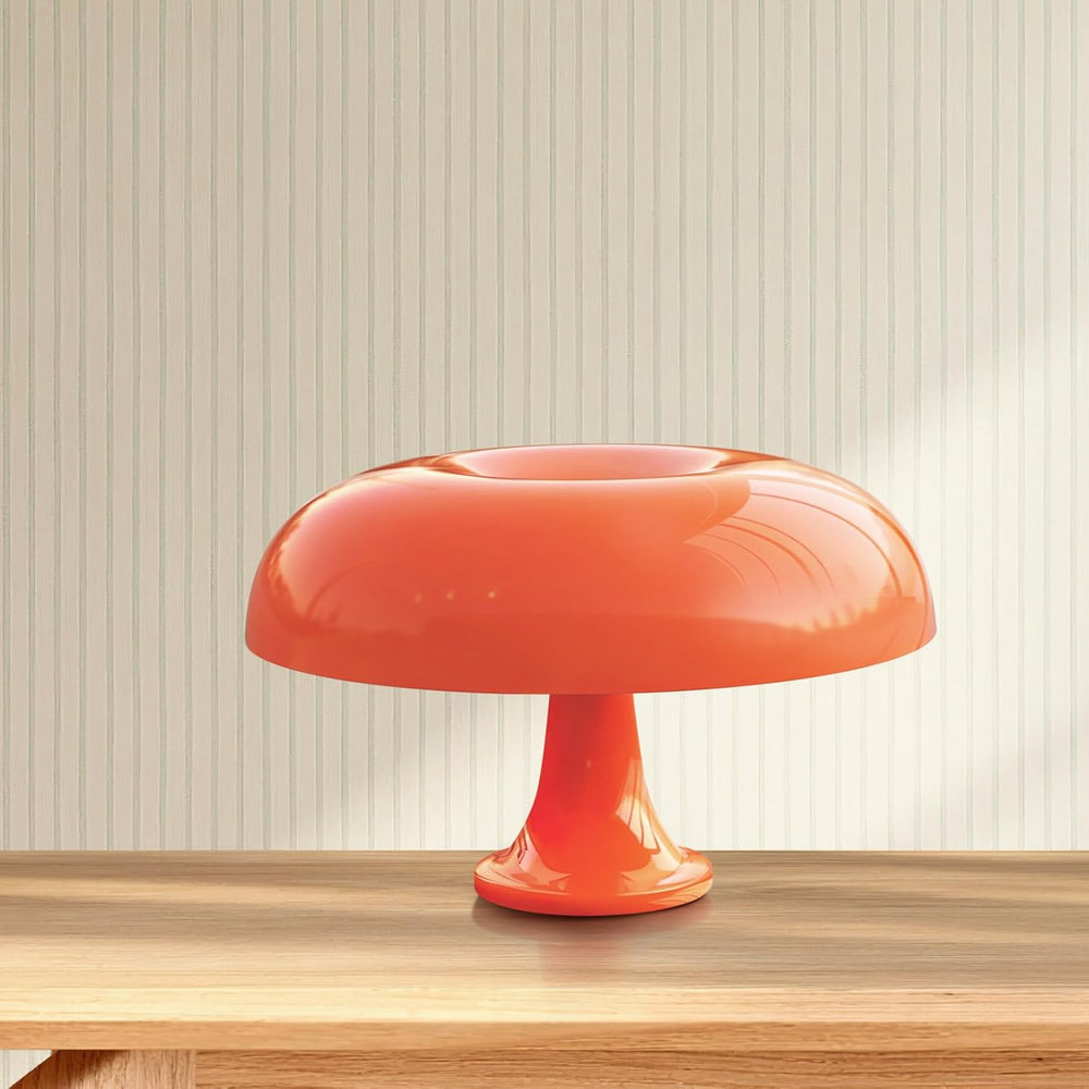 VibeCore Vintage 60s Mushroom Lamp in orange, featuring a retro mushroom shape and warm dimmable light, placed on a desk in a stylish, modern setting.
