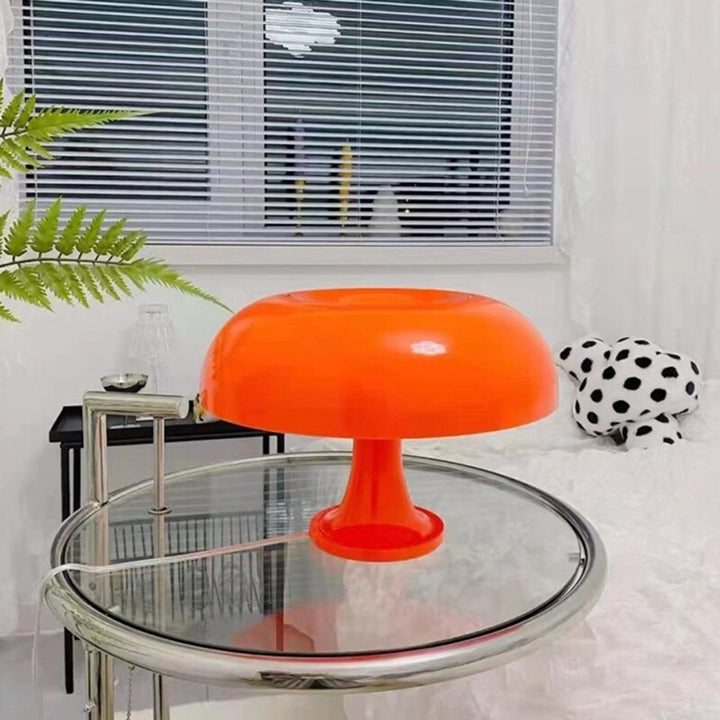 VibeCore Vintage 60s Mushroom Lamp in orange, placed in a bedroom, casting a soft, retro-inspired glow on the nightstand.