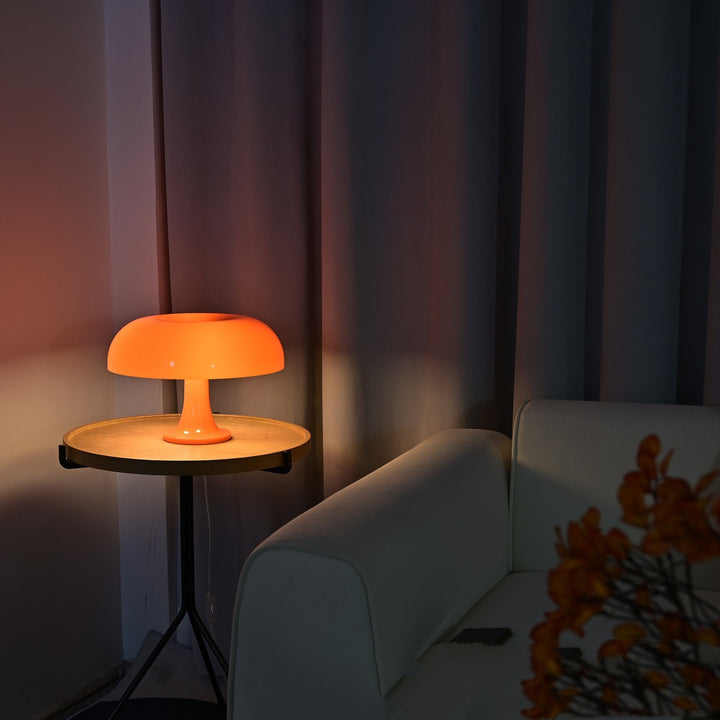 VibeCore Vintage 60s Mushroom Lamp in orange on a side table, casting a warm, retro glow in a cozy, modern living room setting.