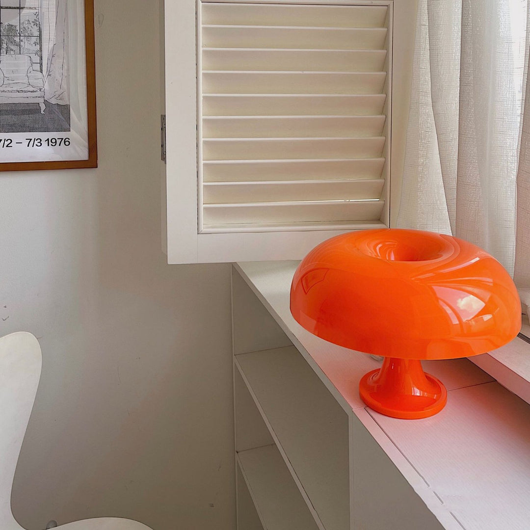 VibeCore Vintage 60s Mushroom Lamp in orange, resting on a windowsill, illuminating the room with a retro, warm glow.