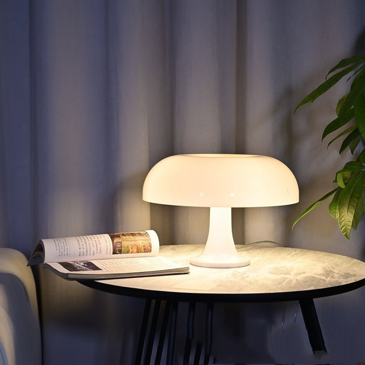 VibeCore Vintage 60s Mushroom Lamp in white, lit up and placed on a side table, adding a cozy and nostalgic glow to the room.