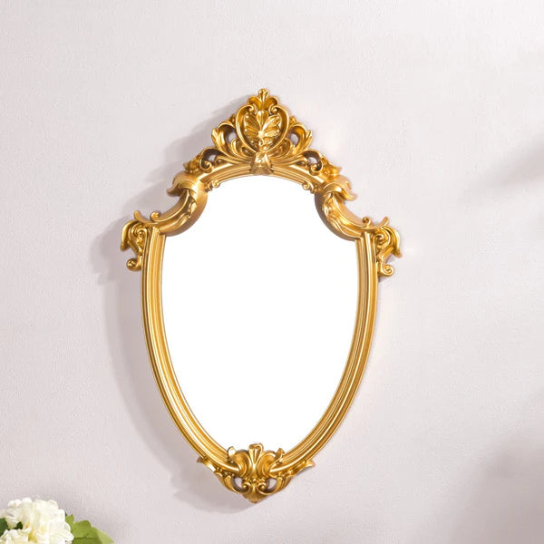 VibeCore Vintage Princess Coquette Mirror hanging on wall, featuring a golden resin frame with European carved design, adding royal elegance and vintage charm to the space.