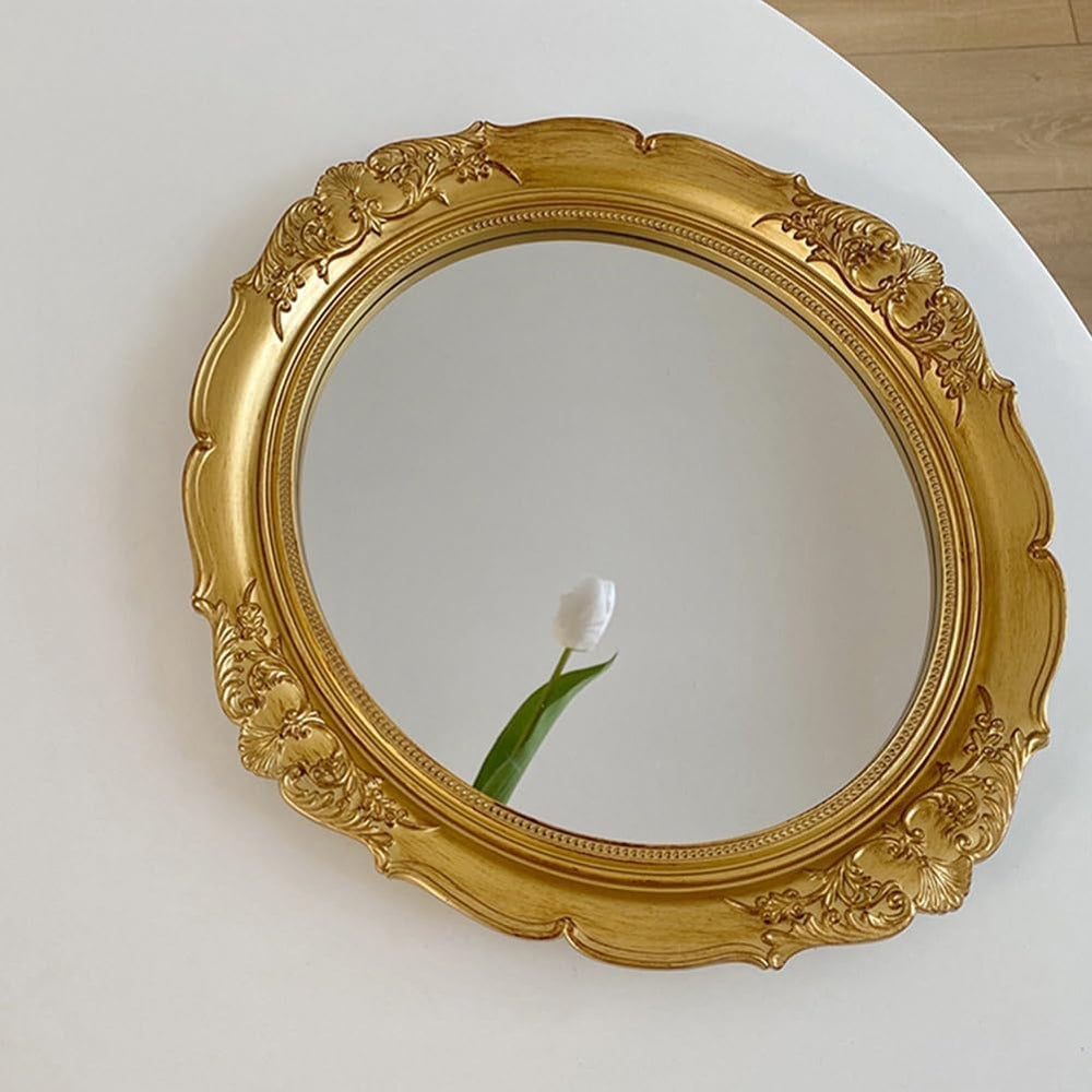 VibeCore Vintage Round Coquette Mirror Gold on table, featuring a vintage resin frame, perfect for adding a coquette aesthetic to your space with its elegant, double-sided design.