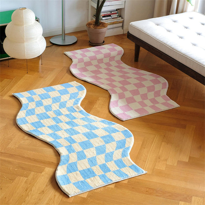 Aesthetic "Wavy Checkerboard Accent Rug" in pink and blue, featuring a dynamic checkerboard pattern with a wavy twist. This soft, plush rug showcases its non-slip backing, making it perfect for adding style and comfort to bedrooms, dorms, or living spaces.