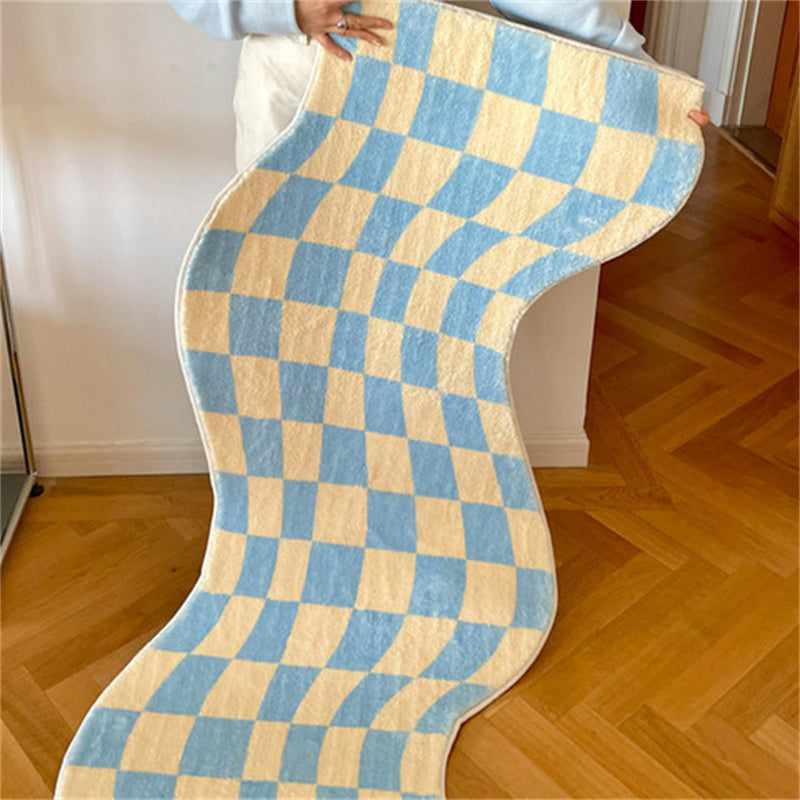 Aesthetic blue "Wavy Checkerboard Accent Rug" being held up, showcasing its dynamic checkerboard pattern with a wavy twist. This close-up highlights the soft, plush texture and non-slip backing, perfect for adding style and comfort to any room.