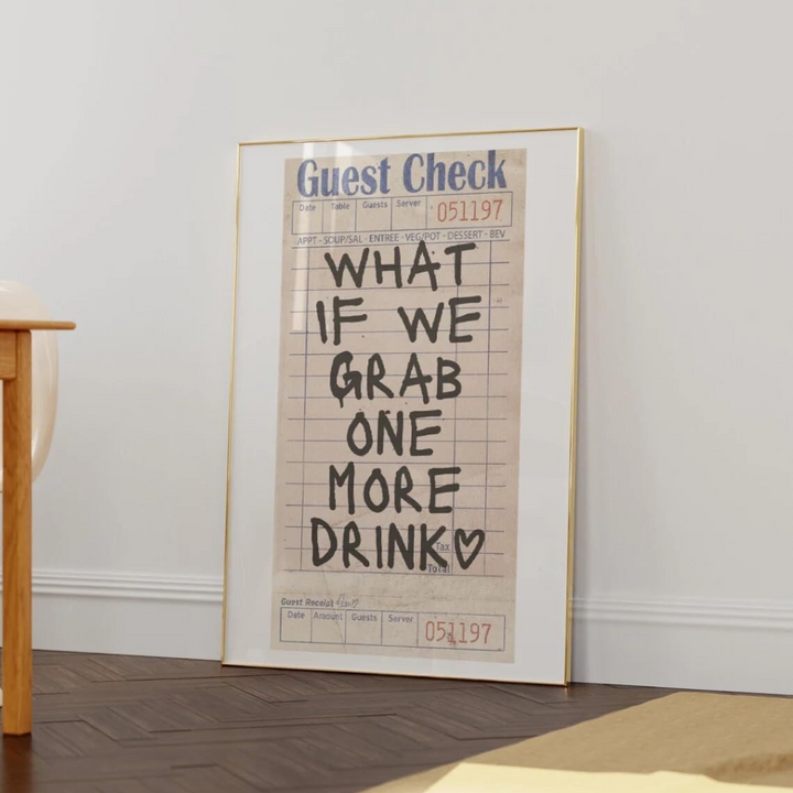 VibeCore 'What If We Grab One More Drink' Canvas Poster leaning against a wall, showcasing bold, contemporary handwriting typography with a playful, girly preppy vibe. This fun, retro-inspired design brings personality and charm to your space, whether in your bedroom, dorm, or apartment. Printed on premium cotton canvas with a semigloss finish for lasting vibrancy and style.