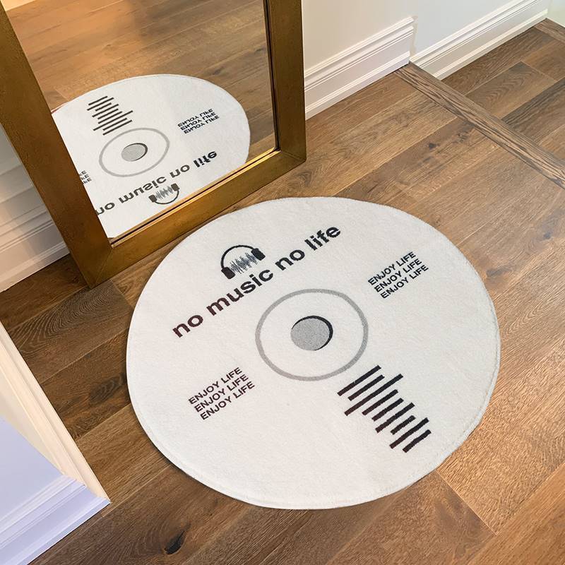 VibeCore White No Music Is Life Accent Rug in front of a mirror, featuring a bold CD design with minimalist typography, round white rug, music-themed decor, modern aesthetic, soft plush texture, non-slip backing, stylish living room or bedroom rug, cozy, urban vibe, statement piece.