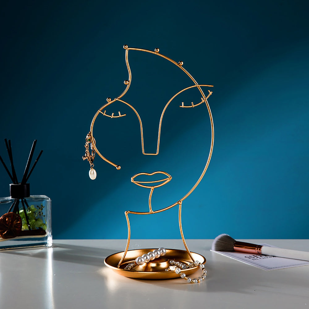 VibeCore Abstract Beauty Jewelry Stand on vanity, showcasing its unique abstract female face design in gold iron metal, perfect for organizing jewelry with style and elegance.
