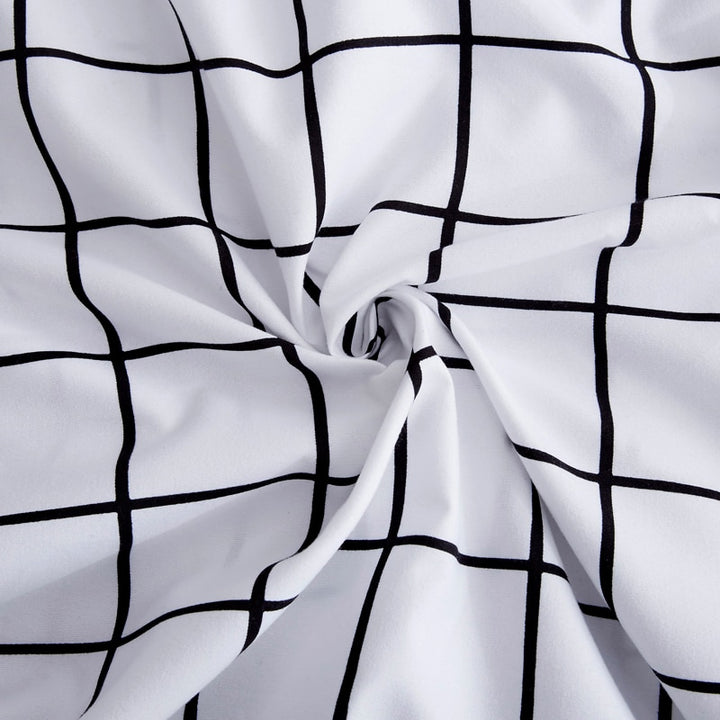 Close-up of the minimalist black-and-white grid pattern on the VibeCore Black and White Grid Bedding Set, highlighting its sleek and modern design. Made from a breathable cotton-polyester blend, this trendy bedding adds a stylish yet cozy touch to any bedroom or dorm decor.