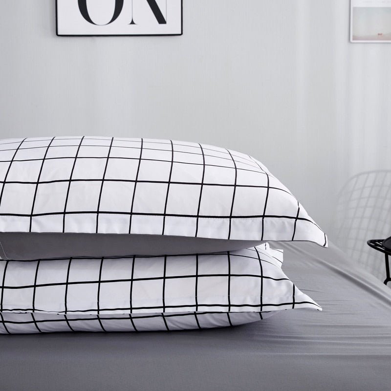 Close-up of pillow covers from the VibeCore Black and White Grid Bedding Set, showcasing the minimalist grid pattern and smooth cotton-polyester blend fabric. Designed for modern bedroom aesthetics, these pillow covers are soft, durable, and fade-resistant, making them the perfect addition to trendy and cozy decor.