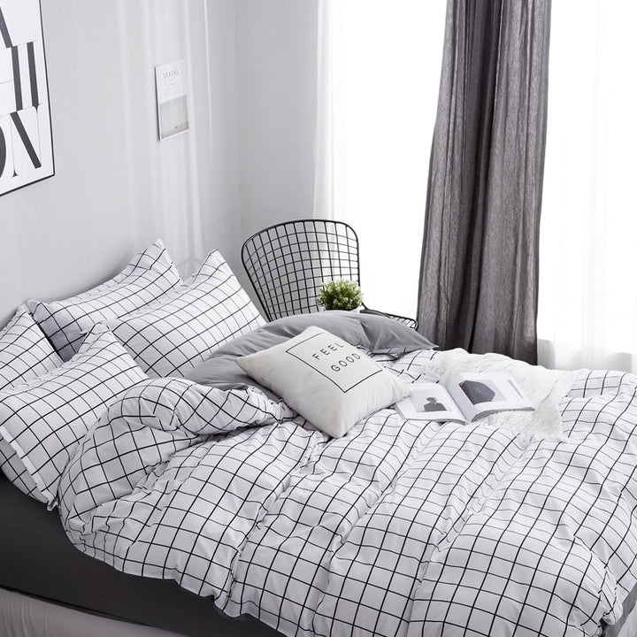 Side view of the VibeCore Black and White Grid Bedding Set, featuring a clean, minimalist grid design on a soft cotton-polyester blend. This bedding set offers breathable comfort, fade resistance, and a stylish modern aesthetic, perfect for upgrading your bedroom or dorm decor with a timeless, Pinterest-inspired look.