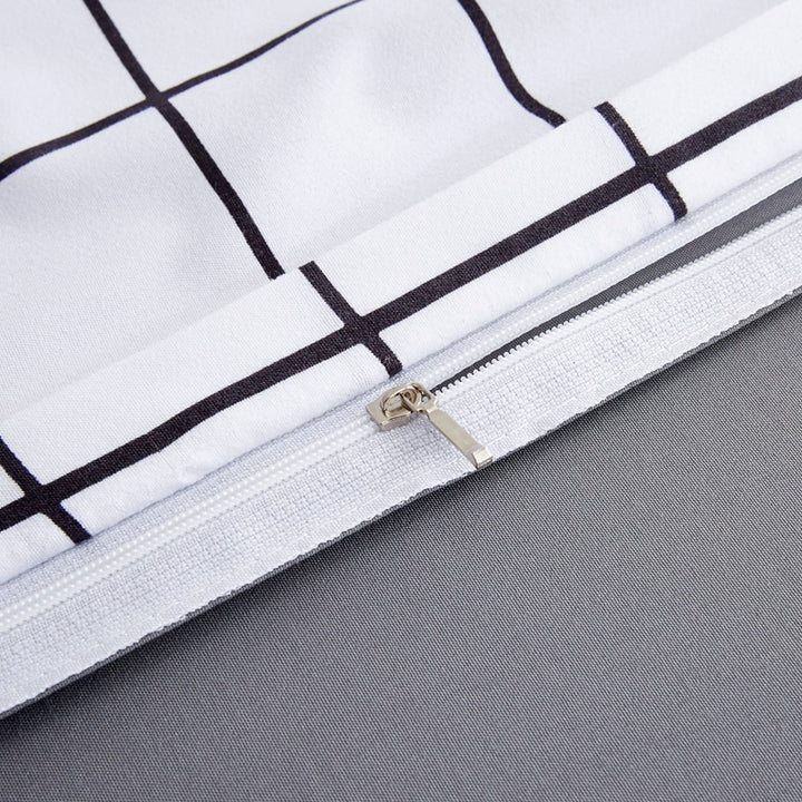 Close-up of the durable zipper closure on the VibeCore Black and White Grid Bedding Set, showcasing its sleek design and practicality. This high-quality feature ensures easy duvet insertion and a secure fit, complementing the bedding's minimalist black-and-white grid pattern and cozy cotton-polyester blend.