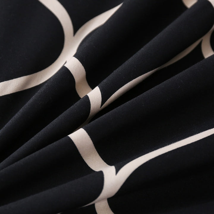 Close-up of the soft cotton-polyester blend material of the VibeCore Aesthetic Black Beehive Duvet Cover Set, showcasing its smooth texture and durability. The bold black and gold beehive pattern adds modern style, offering both comfort and sophistication for any bedroom or dorm room.