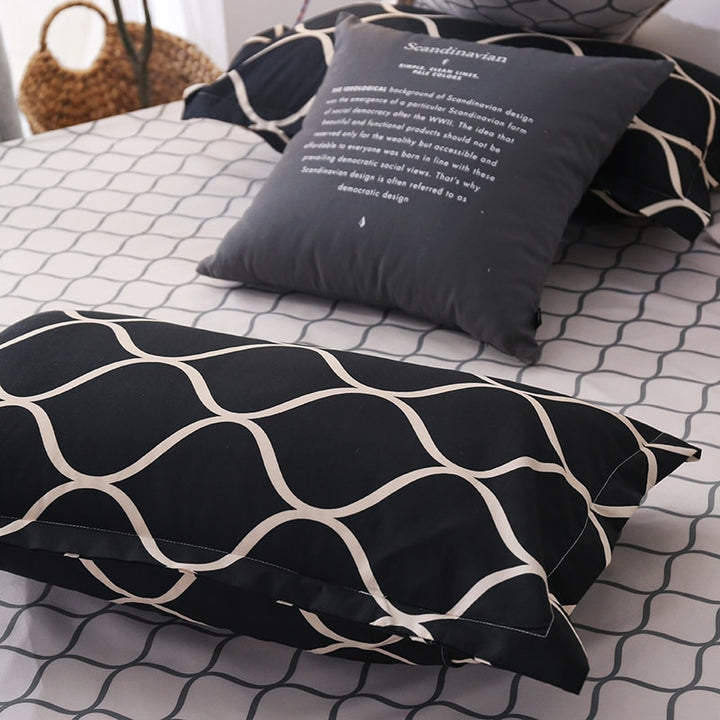 Close-up of the VibeCore Aesthetic Black Beehive Pillowcase, featuring a bold black and gold beehive pattern. Made from a soft cotton-polyester blend, this pillowcase adds a touch of modern elegance and comfort, perfectly complementing the duvet cover set.