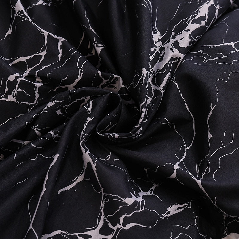 Close-up of the soft cotton-polyester blend material of the VibeCore Aesthetic Black Marble Duvet Cover Set, highlighting its smooth texture and durability. This fabric offers year-round comfort while the sleek black marble design adds modern elegance to your bedroom or dorm.