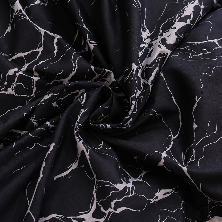 Close-up of the soft cotton-polyester blend material of the VibeCore Aesthetic Black Marble Duvet Cover Set, highlighting its smooth texture and durability. This fabric offers year-round comfort while the sleek black marble design adds modern elegance to your bedroom or dorm.