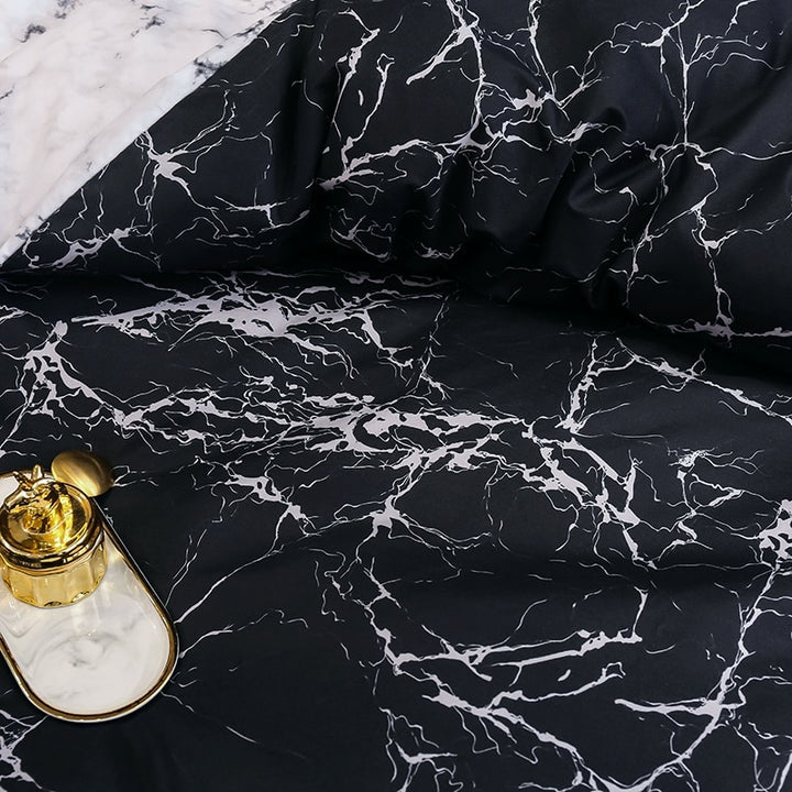 Close-up of the VibeCore Aesthetic Black Marble Duvet Cover Set pattern, showcasing the sleek, sophisticated black marble design. The elegant pattern, combined with the durable cotton-polyester blend, adds a modern, chic touch to your bedroom or dorm while providing year-round comfort.