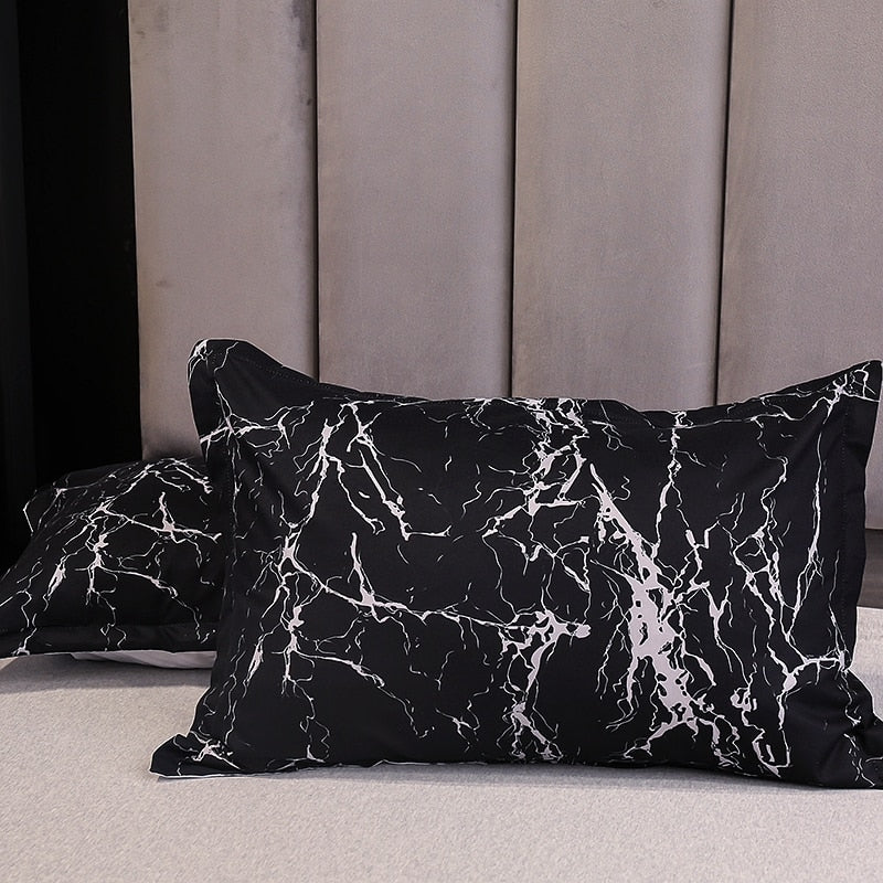 Close-up of the VibeCore Aesthetic Black Marble Duvet Cover Set pillowcases, featuring the sleek black marble design. Made from a soft and durable cotton-polyester blend, these pillowcases complement the duvet cover with modern sophistication, offering comfort and style for your bedroom or dorm.