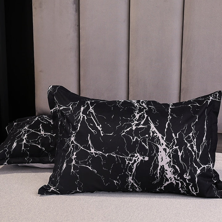 Close-up of the VibeCore Aesthetic Black Marble Duvet Cover Set pillowcases, featuring the sleek black marble design. Made from a soft and durable cotton-polyester blend, these pillowcases complement the duvet cover with modern sophistication, offering comfort and style for your bedroom or dorm.