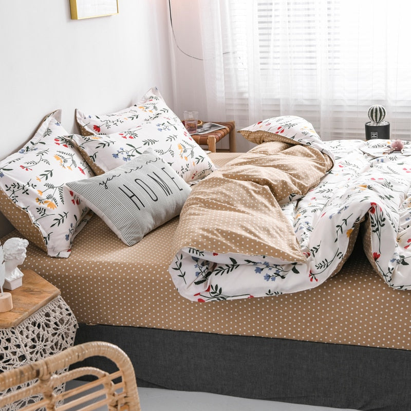 Side view of the VibeCore Aesthetic Colorful Flower Duvet Cover Set, showcasing the vibrant floral patterns in bold colors on the duvet cover and the mustard yellow, white polka-dot sheet. Crafted from a soft cotton-polyester blend, this duvet cover set adds a lively, nature-inspired touch to any bedroom or dorm room, offering both style and comfort.