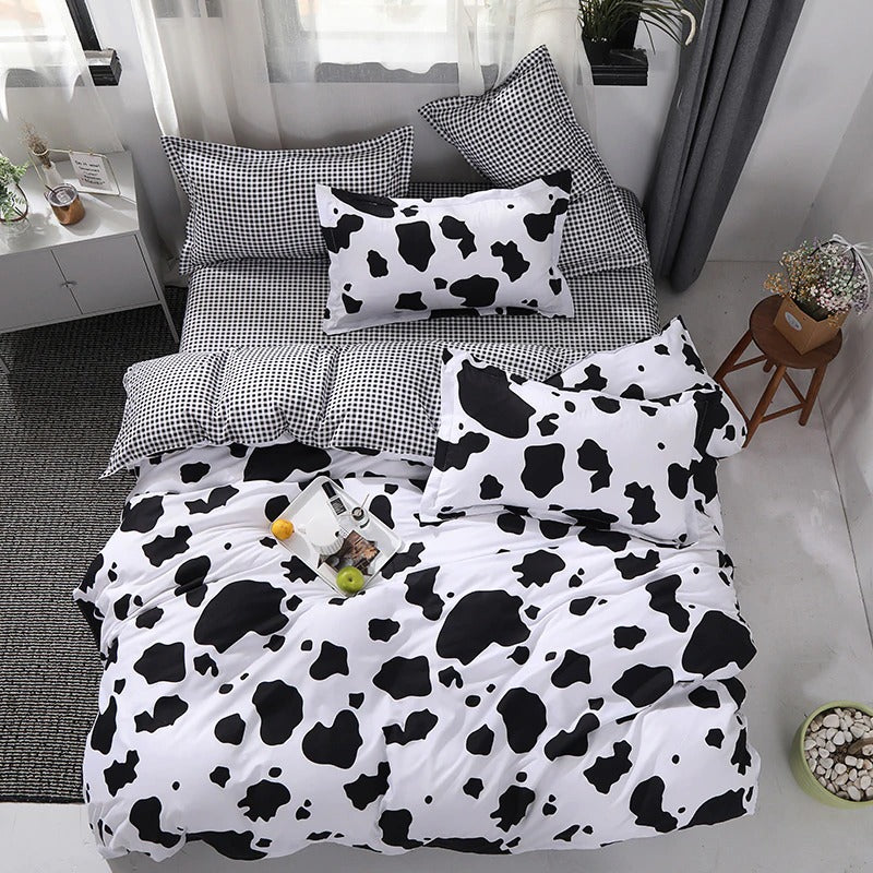 Aerial view of the VibeCore Cow Print Bedding Set, showcasing the bold cow print pattern and the soft cotton-polyester blend fabric. This trendy bedding set transforms your bed into a stylish focal point, offering comfort and eye-catching design for any season.