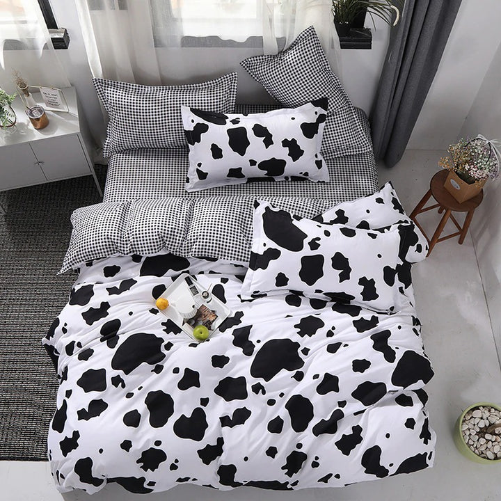 Aerial view of the VibeCore Cow Print Bedding Set, showcasing the bold cow print pattern and the soft cotton-polyester blend fabric. This trendy bedding set transforms your bed into a stylish focal point, offering comfort and eye-catching design for any season.