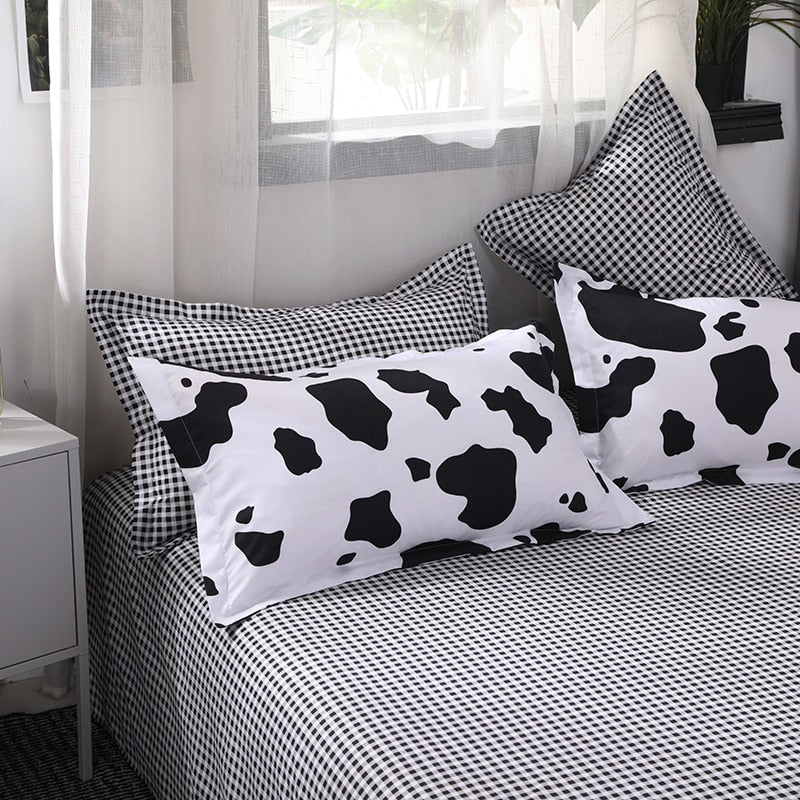 Close-up of pillow covers and sheet of the VibeCore Cow Print Bedding Set, showcasing the unique cow print design and soft cotton-polyester blend fabric for maximum comfort and style in your bedroom.