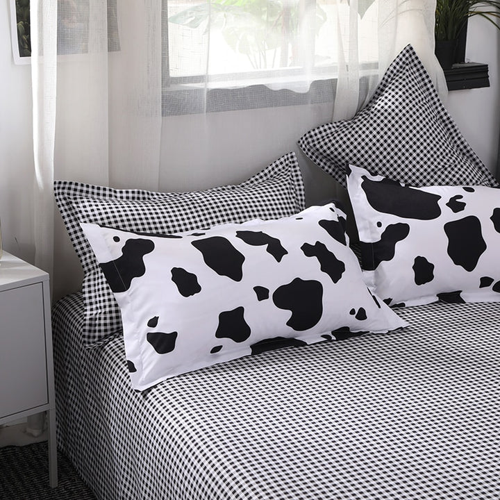 Close-up of pillow covers and sheet of the VibeCore Cow Print Bedding Set, showcasing the unique cow print design and soft cotton-polyester blend fabric for maximum comfort and style in your bedroom.