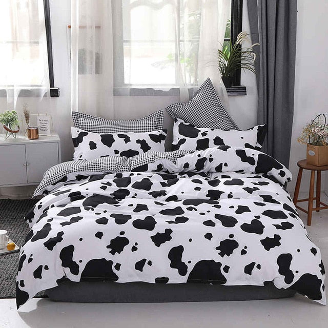 Full view of the VibeCore Cow Print Bedding Set, featuring the bold and trendy cow print pattern across the duvet cover and pillowcases. Made from a cozy cotton-polyester blend, this bedding set adds a playful, chic vibe to your room while ensuring comfort throughout the year.