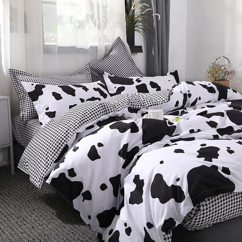 Side view of the VibeCore Cow Print Bedding Set, showcasing the bold cow print pattern along the duvet cover and pillowcases. Crafted from a soft cotton-polyester blend, this bedding set combines playful design with year-round comfort, perfect for adding a trendy touch to your bedroom.