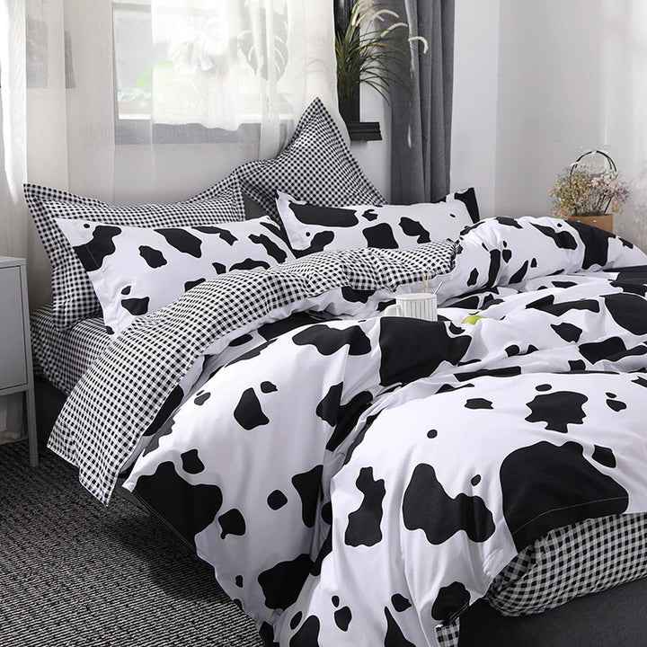 Side view of the VibeCore Cow Print Bedding Set, showcasing the bold cow print pattern along the duvet cover and pillowcases. Crafted from a soft cotton-polyester blend, this bedding set combines playful design with year-round comfort, perfect for adding a trendy touch to your bedroom.