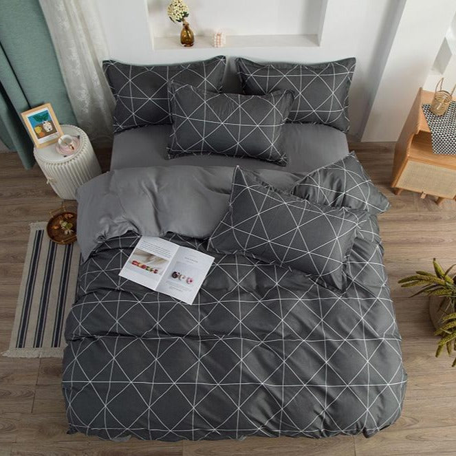 Aerial view of VibeCore Aesthetic Gray Geometric Duvet Cover Set featuring modern geometric patterns in shades of gray. Crafted from a soft cotton-polyester blend, this bedding set offers year-round comfort and stylish elegance, perfect for contemporary bedrooms or dorms.