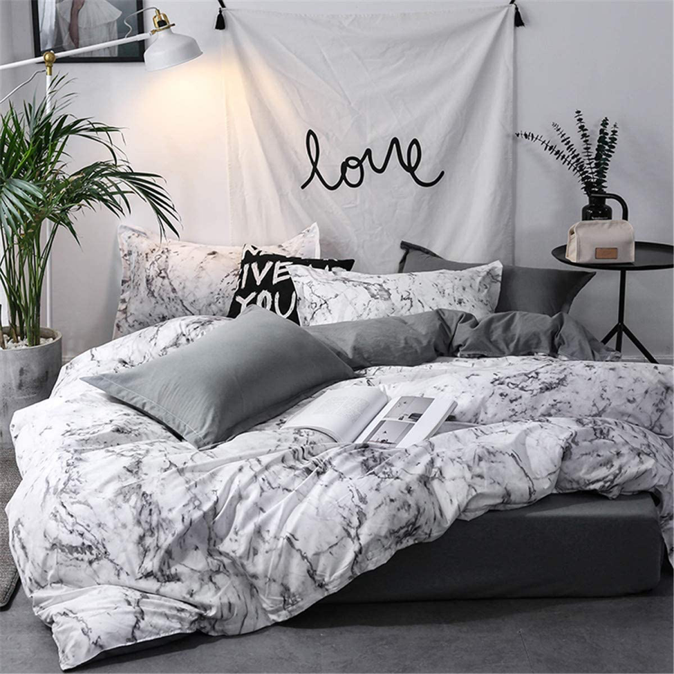 Front view of VibeCore Aesthetic White Marble Duvet Cover Set showcasing the sleek marble design. Made with a soft cotton-polyester blend, this duvet set offers both comfort and durability. Its minimalist white marble pattern adds elegance to any modern bedroom or dorm, while the breathable fabric ensures year-round coziness. Machine washable for easy maintenance, available in Queen/King and Single/Twin sizes.