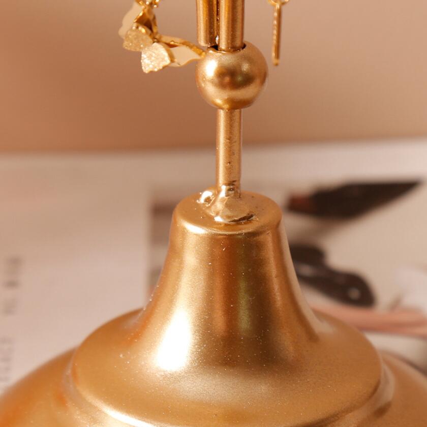 Close-up of the base of the VibeCore Arrow Jewelry Stand in Gold, showcasing its sturdy metal construction and sleek, minimalist design for a stable jewelry display.