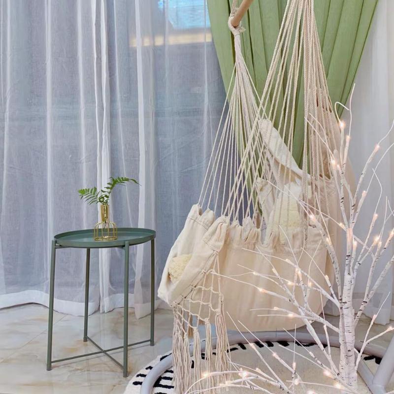 Aesthetic side view of the Bohemia style hanging hammock chair made of high-quality cotton thread perfect for adding a cozy, bohemian touch to your space while providing durable comfort for lounging or reading.