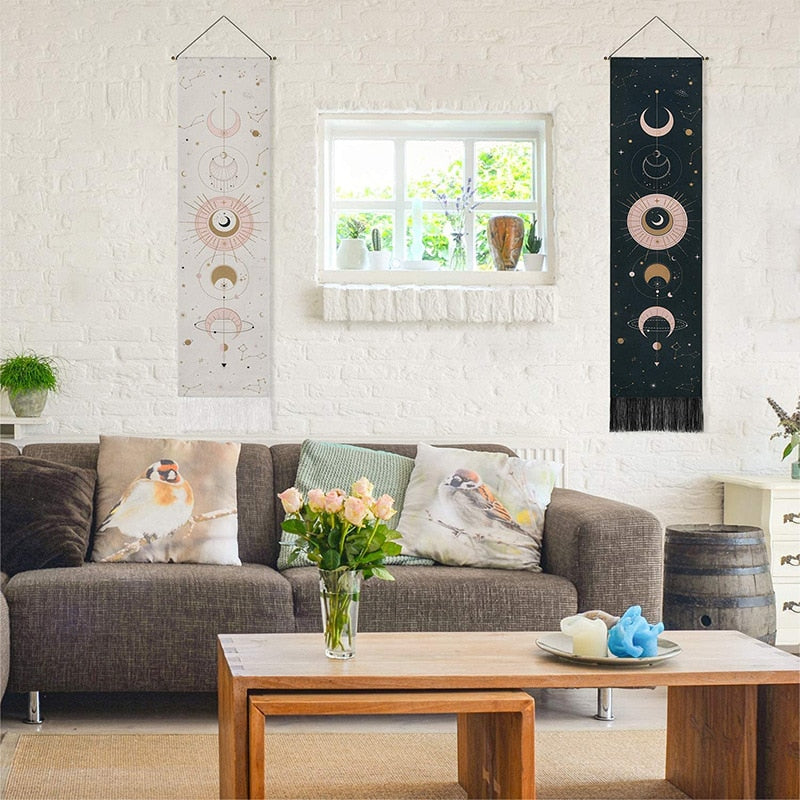 Celestial Moon Phases Wall Hanging in black and white on a wall in the living room behind the couch, adding a mystical, boho-chic touch with its moon phase design to the space.