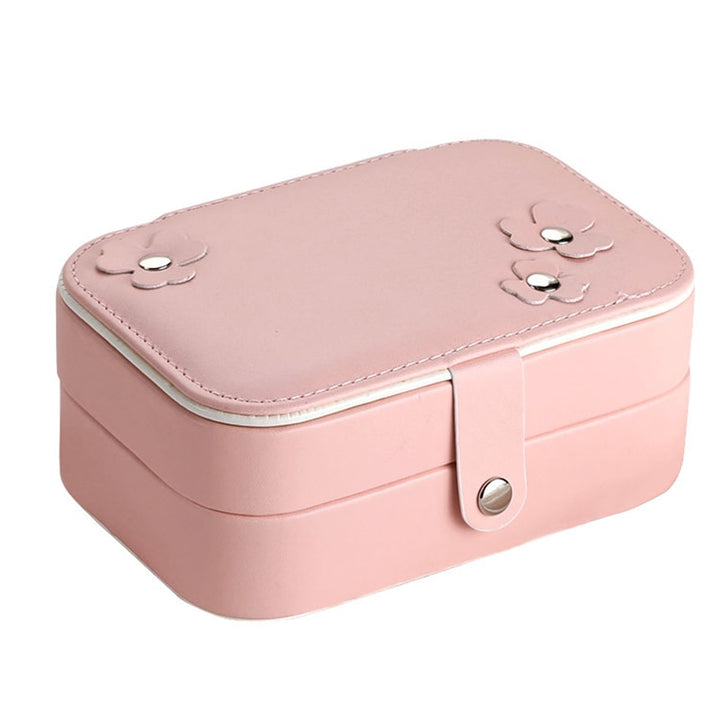 Light pink jewelry organizer with a sleek, compact design. Durable synthetic leather exterior and secure closure, perfect for travel or home storage.